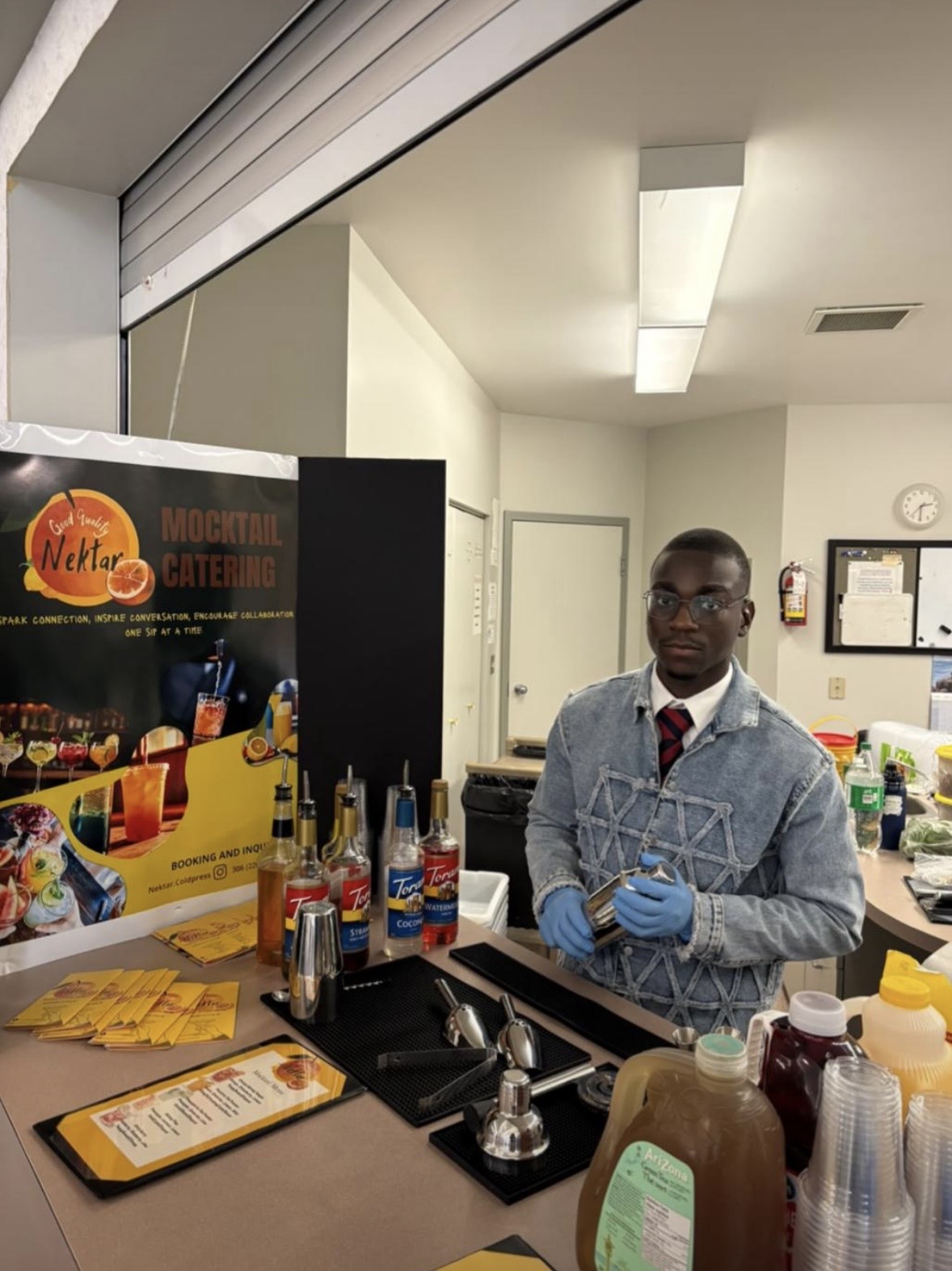 Nektar bartender behind a branded mocktail catering bar setup