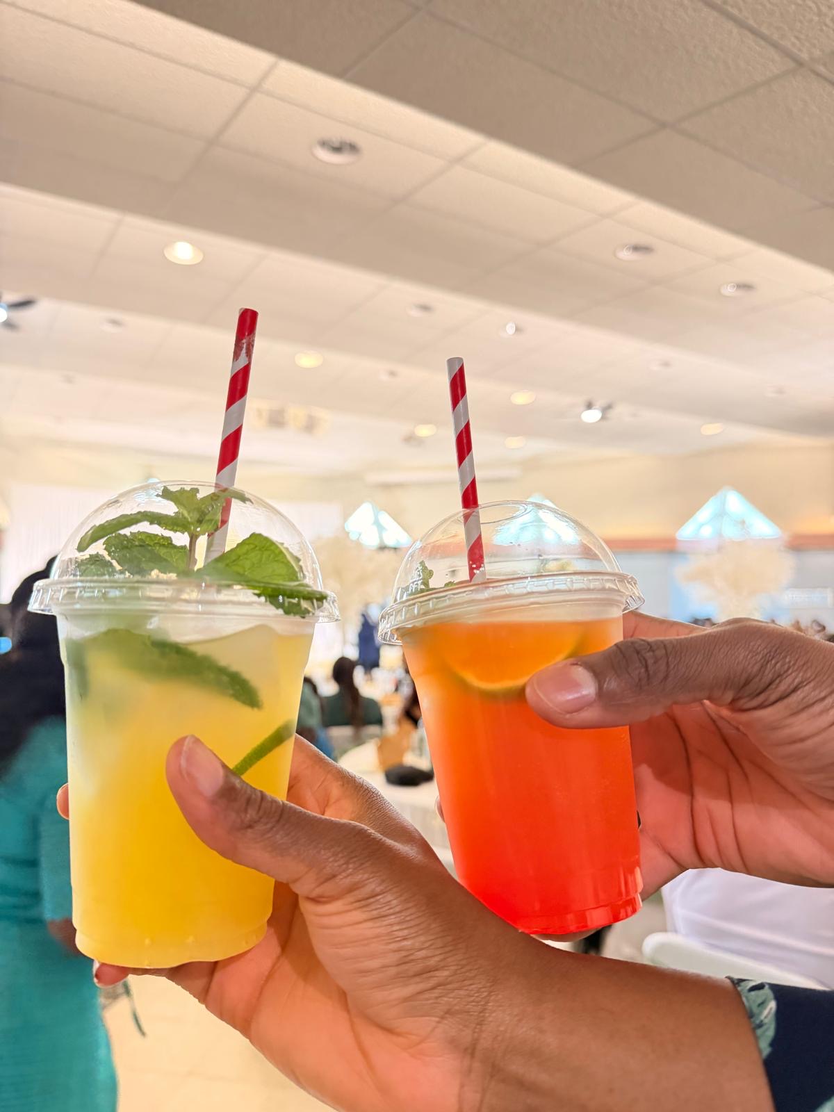 Two guests toasting with mint and berry mocktails at a reception